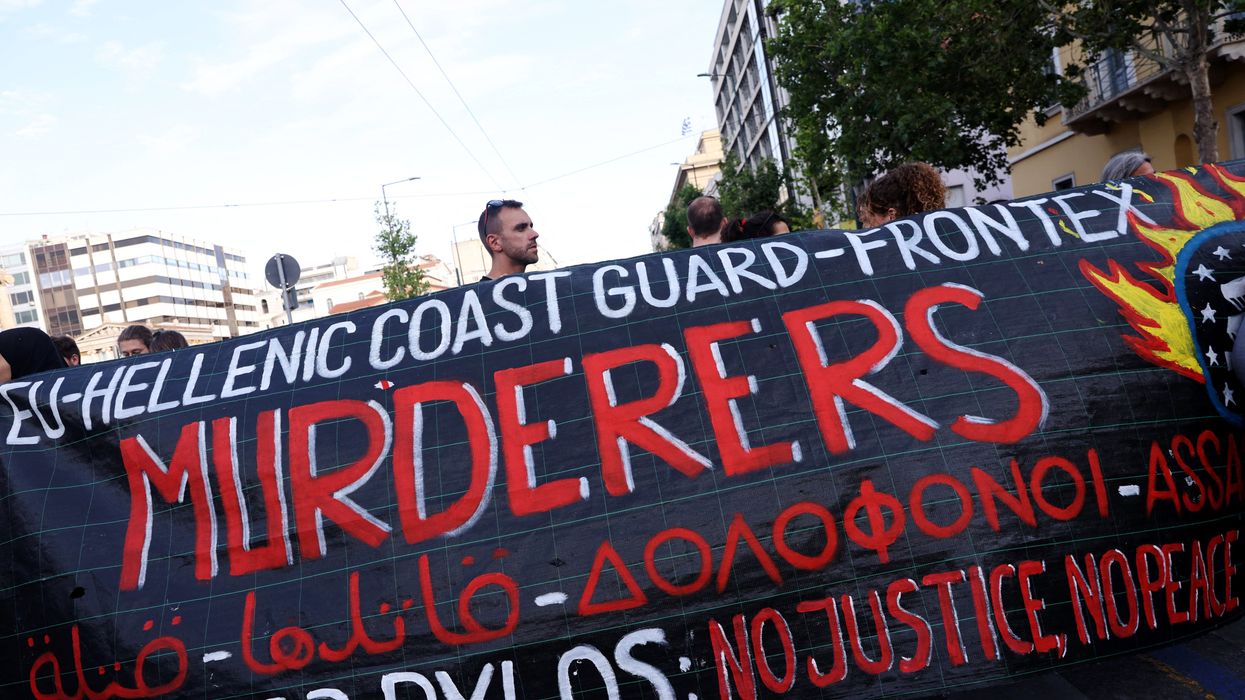 Protesters hold a banner during a demonstration in Athens following a deadly migrant shipwreck off Greece.