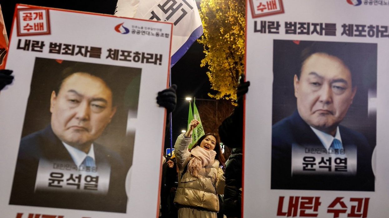 Protesters hold placards during a candlelight vigil to condemn South Korean President Yoon Suk Yeol's surprise declarations of the failed martial law and to call for his resignation in Seoul, South Korea, December 5, 2024.