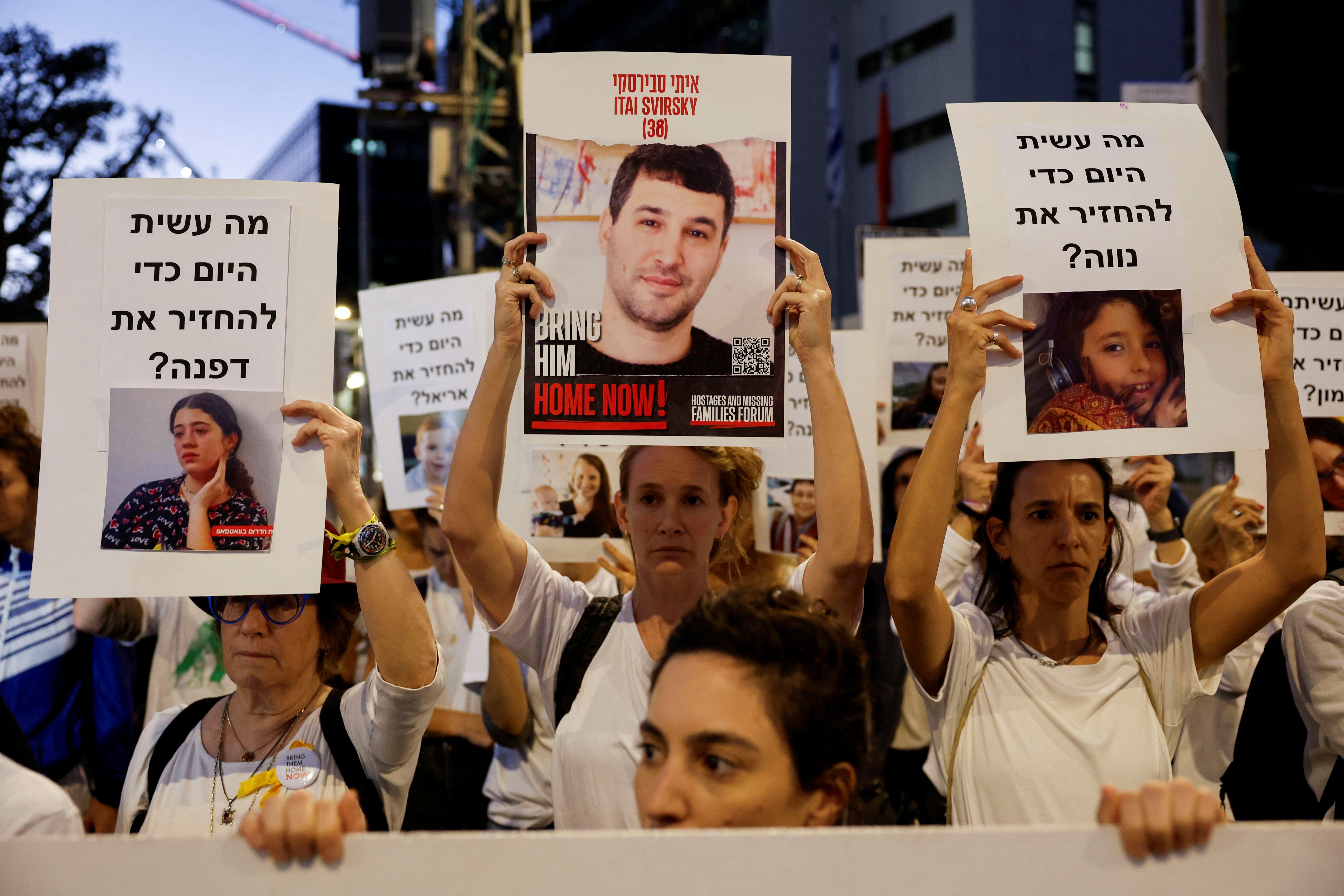 Protesters hold signs demanding the liberation of hostages being held in the Gaza Strip after they were seized by Hamas gunmen on Oct. 7, in Tel Aviv, on Nov. 21, 2023, just hours before the announcement of a four-day cease-fire.
