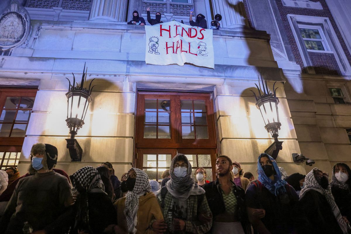 ​Protesters link arms outside Hamilton Hall barricading students inside the building at Columbia University, despite an order to disband the protest encampment supporting Palestinians or face suspension, during the ongoing conflict between Israel and the Palestinian Islamist group Hamas, in New York City, U.S., April 30, 2024. 