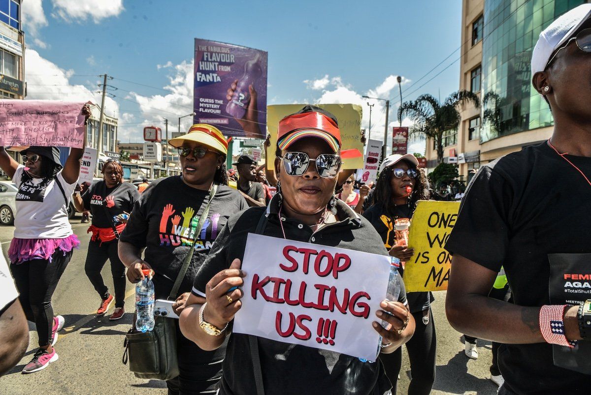 ​Protesters march while carrying placards and chanting slogans in the "Feminists March Against Femicide" in Kenya. 
