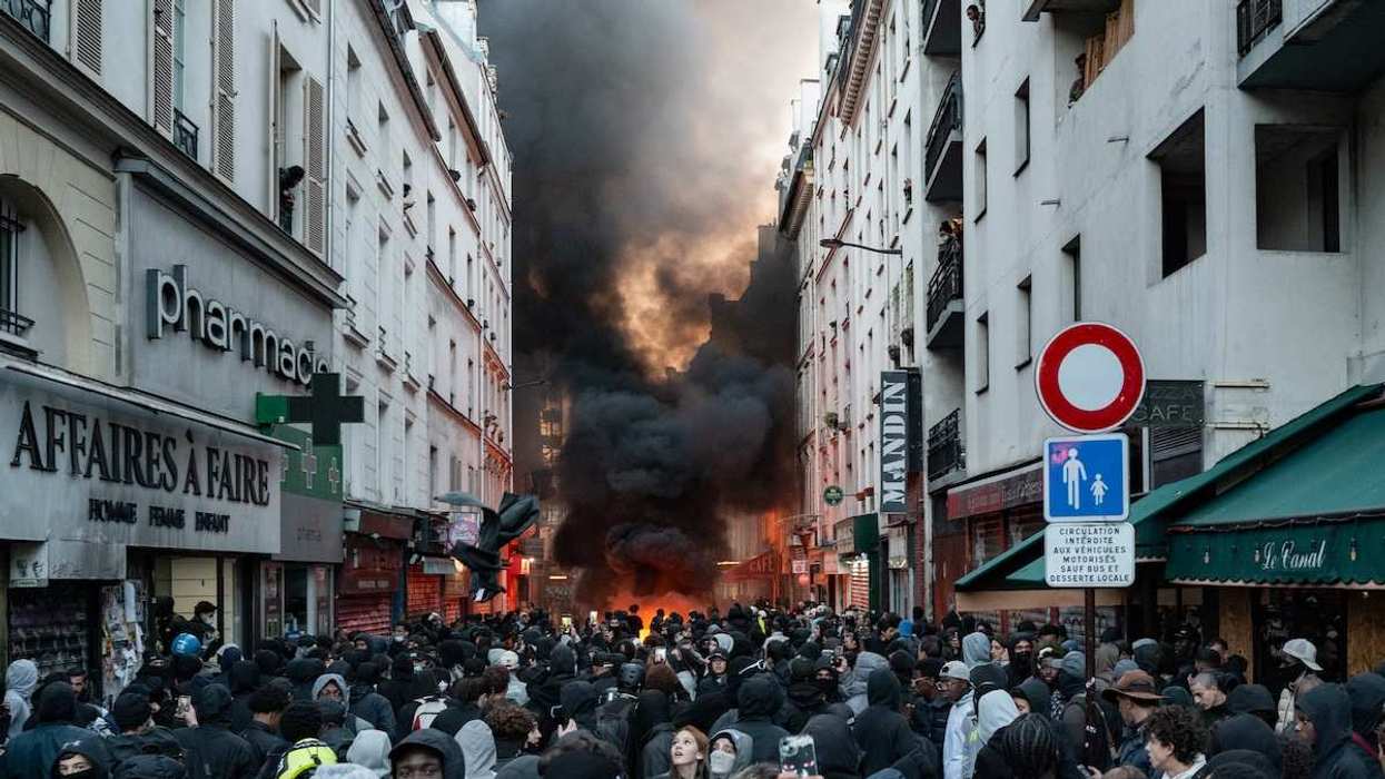 Protesters set up barricades and burn materials near Place de la Republique in Paris, France, on October 18, 2026, the day following a large demonstration.