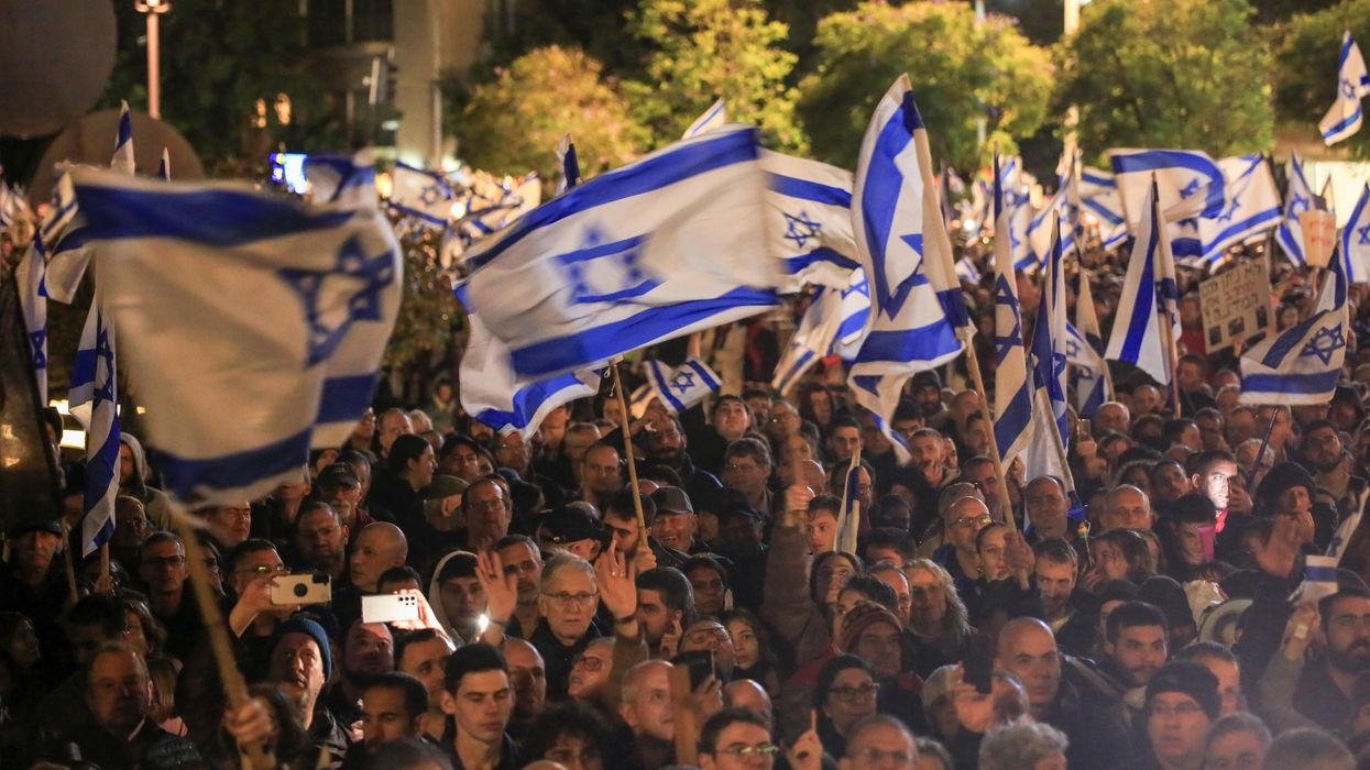 Protesters wave flags during a demonstration in Tel Aviv.