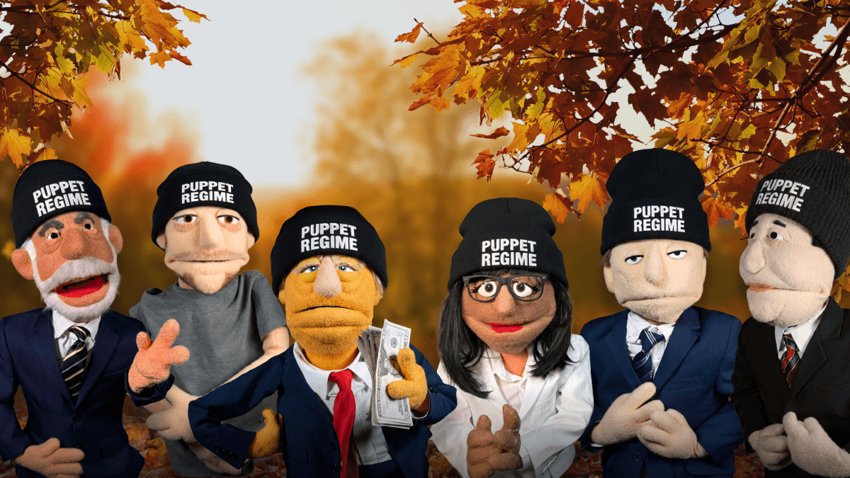 Puppets wearing a Puppet Regime beanie with a fall background