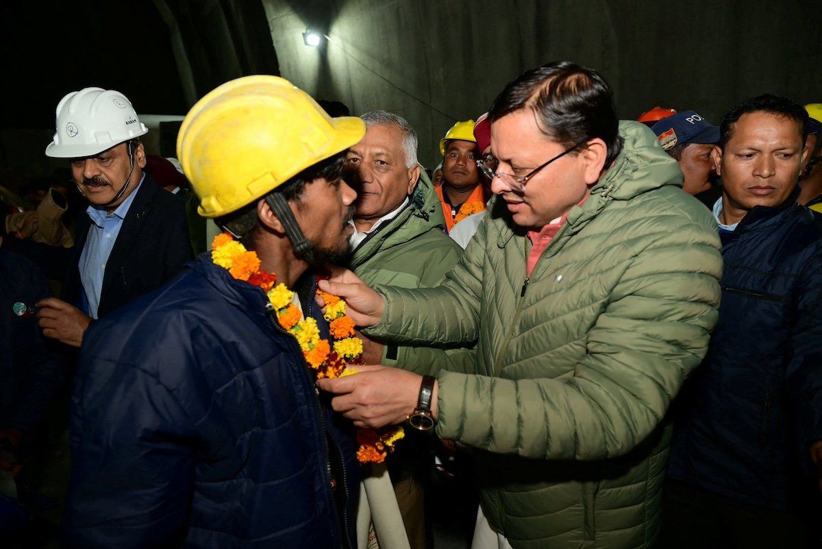 Pushkar Singh Dhami, Chief Minister of the northern state of Uttarakhand, greets a worker after he was rescued from the collapsed tunnel site in Uttarkashi, Uttarakhand, India, November 28, 2023.