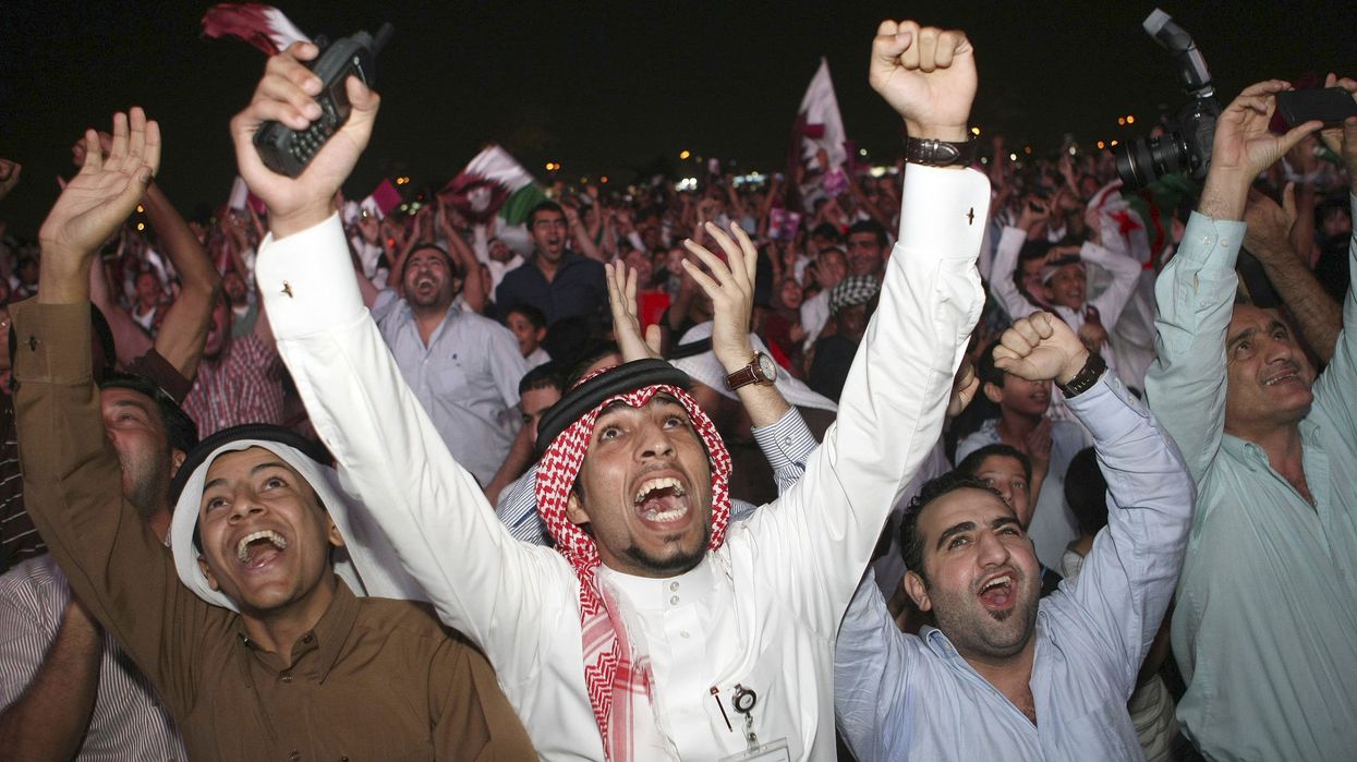 Qatari fans celebrate after the announcement that Qatar will host the 2022 World Cup