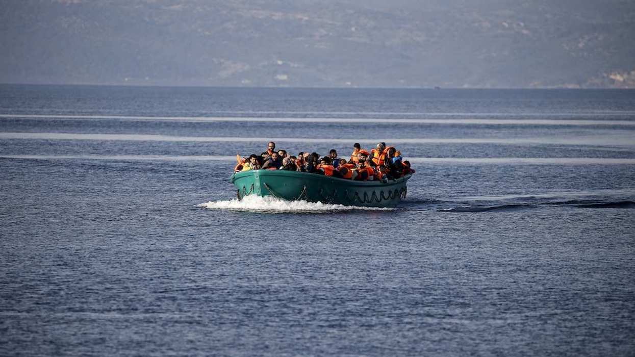Refugees and migrants arrive on an overcrowded boat on the Greek island of Lesbos, November 10, 2015. Since the start of the year, over 590,000 people have crossed into Greece, the frontline of a massive westward population shift from war-ravaged Syria and beyond.