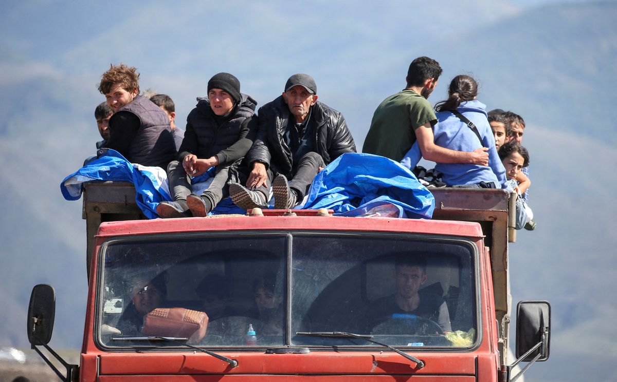 Refugees from Nagorno-Karabakh region ride in a truck upon their arrival at the border village of Kornidzor, Armenia, September 27, 2023.
