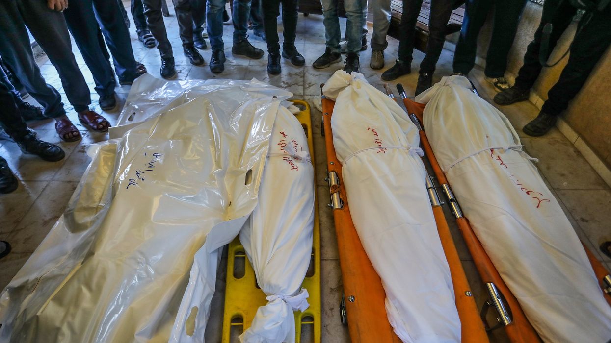 Relatives of Palestinians, who lost their lives following the Israeli attack on a makeshift displacement camp in Mawasi Khan Yunis, mourn as the bodies are brought to Nasser Hospital for burial process.