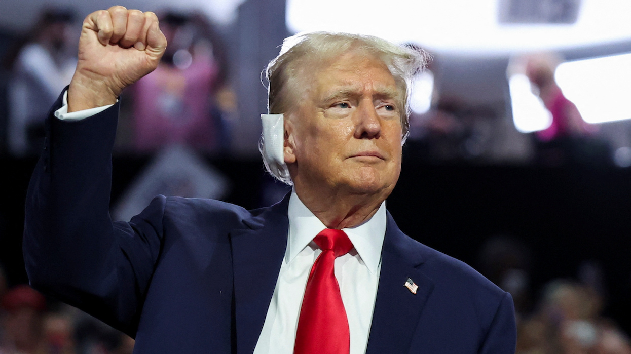 Republican presidential nominee and former President Donald Trump raises his fist during Day 1 of the Republican National Convention in Milwaukee, Wisconsin, on July 15, 2024.