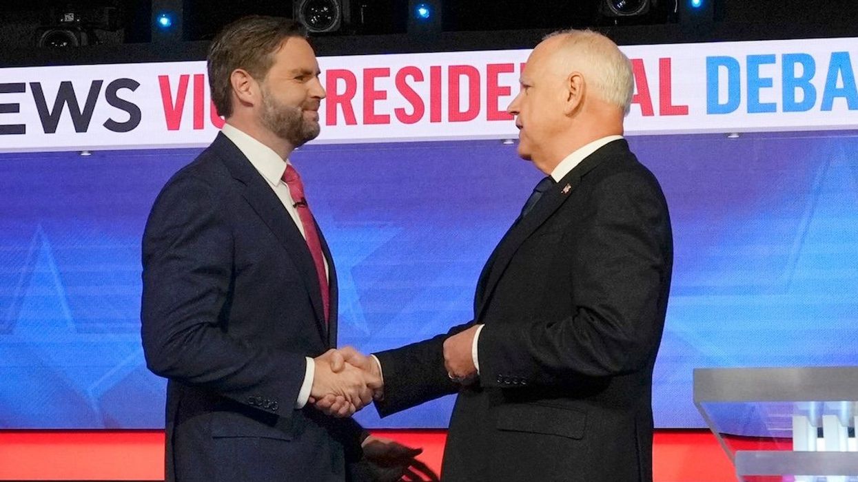 Republican Sen. JD Vance and Democrat Gov. Tim Walz greet each other before they square off during the CBS News vice presidential debate in New York City on Oct. 1, 2024.