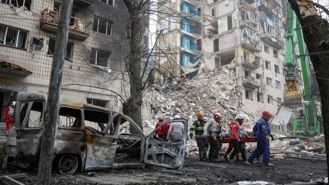 Rescuers carry a body at the site of an apartment building damaged during a Russian strike, amid Russia's attack on Ukraine, in Kyiv, Ukraine June 17, 2025.