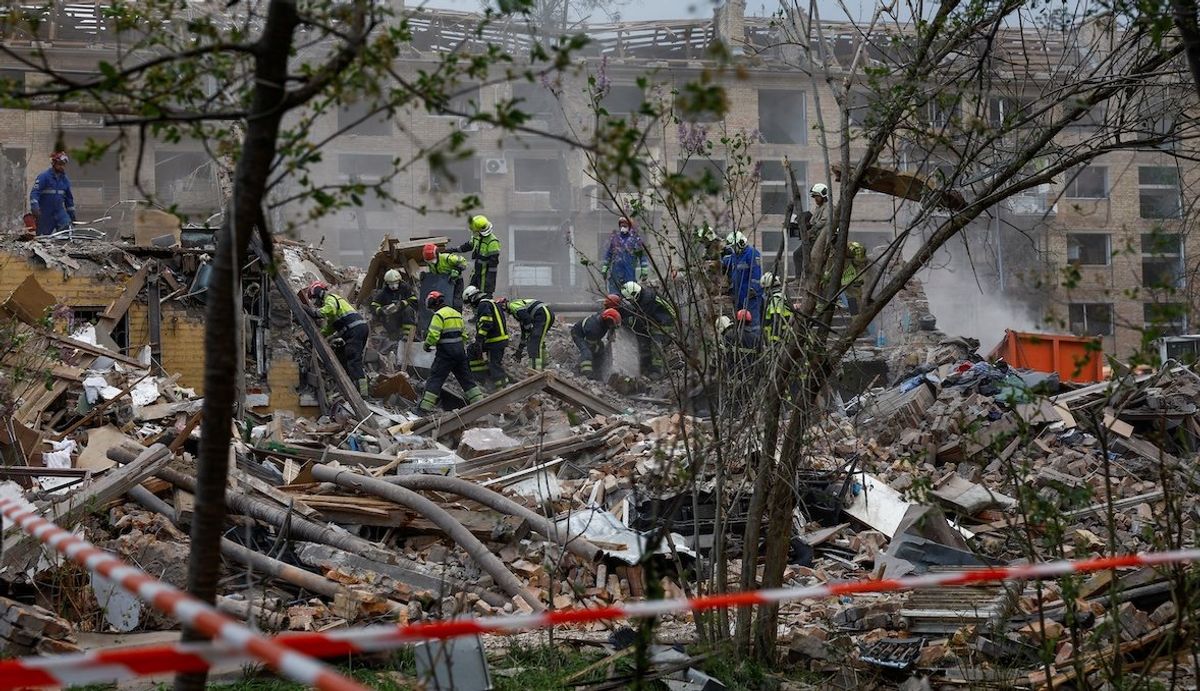 Rescuers search for a 17-year-old and his parents near an apartment building hit by a Russian missile strike, amid Russia's attack on Ukraine, in Kyiv, on April 24, 2025. 
