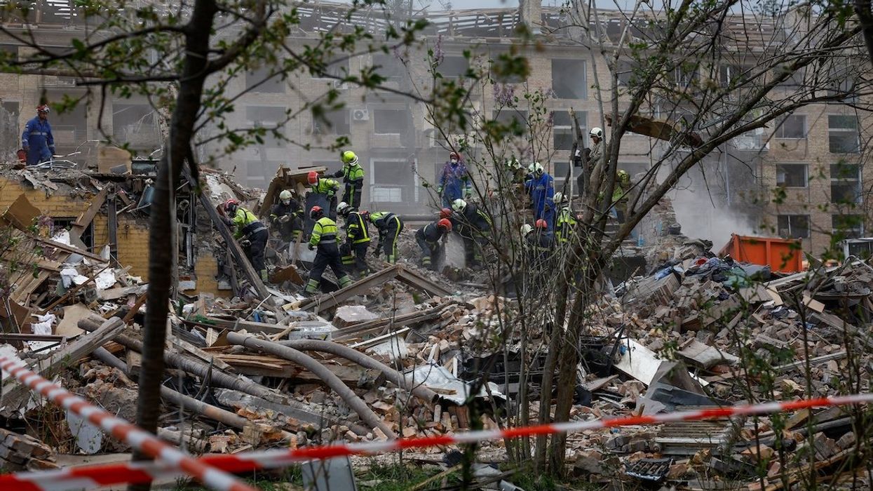 Rescuers search for a 17-year-old and his parents near an apartment building hit by a Russian missile strike, amid Russia's attack on Ukraine, in Kyiv, on April 24, 2025.