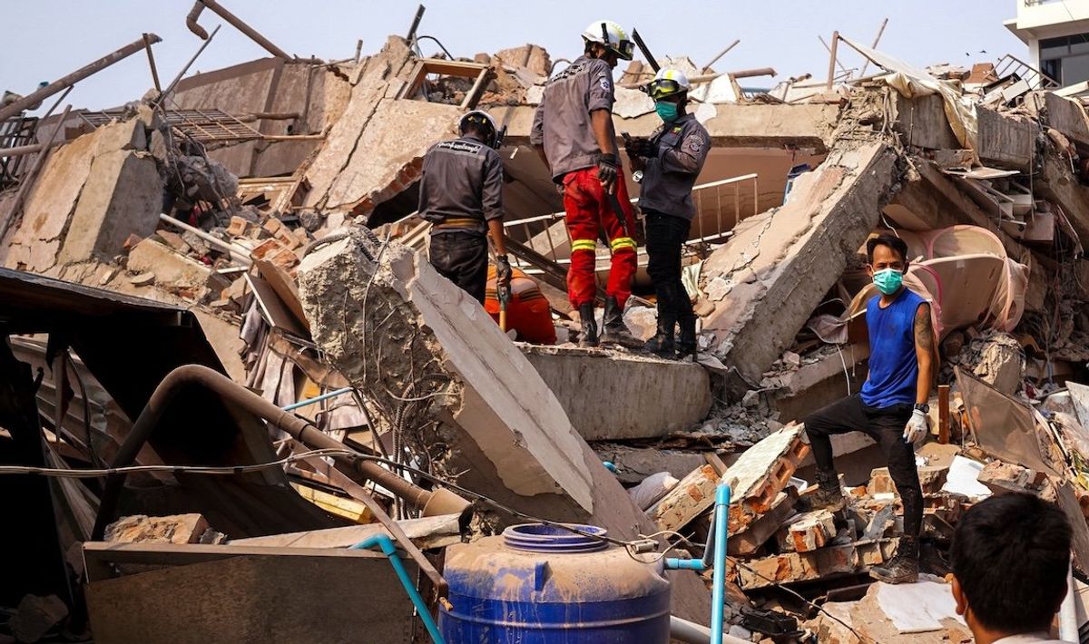 ​Rescuers work at the site of a building that collapsed after the strong earthquake in Mandalay, Myanmar, on Sunday, March 30, 2025. 