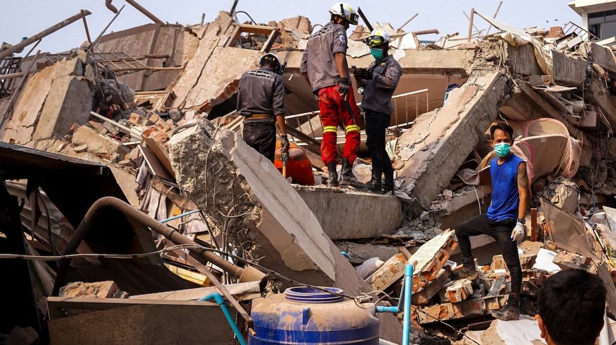 Rescuers work at the site of a building that collapsed after the strong earthquake in Mandalay, Myanmar, on Sunday, March 30, 2025.