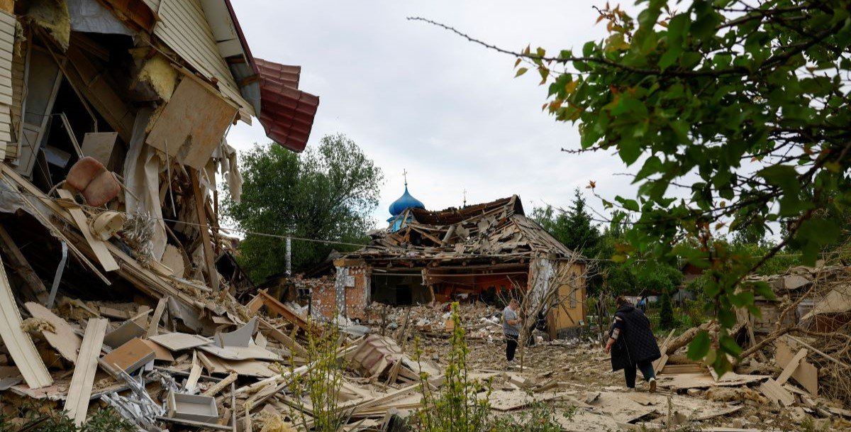 ​Residents are seen next to houses heavily damaged by a Russian drone strike, amid Russia's attack on Ukraine, outside of Kyiv, Ukraine May 18, 2025. 