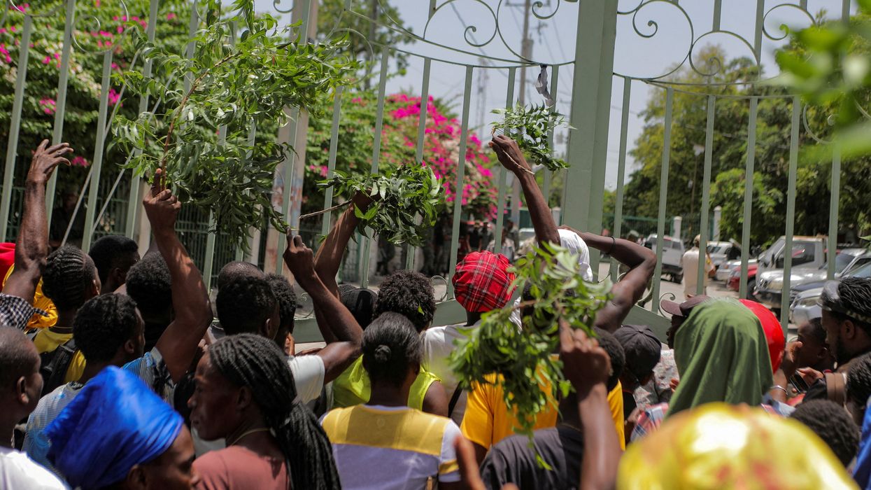 Residents of the Carrefour Feuilles neighborhood gather outside a military base demanding help after they had to flee their homes when gangs took over, in Port-au-Prince, Haiti, in August 2023.