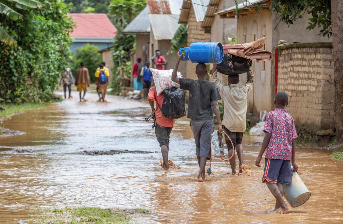 Residents wade through water after major flooding and landslides in Rwanda.