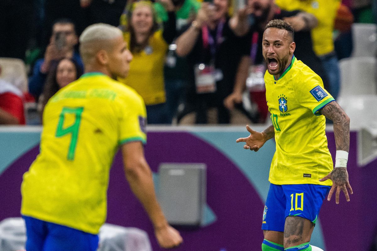 Richarlison (L) and Neymar (R) of Brazil celebrate after scoring the first goal during the FIFA World Cup 2022 match against Serbia in Doha.