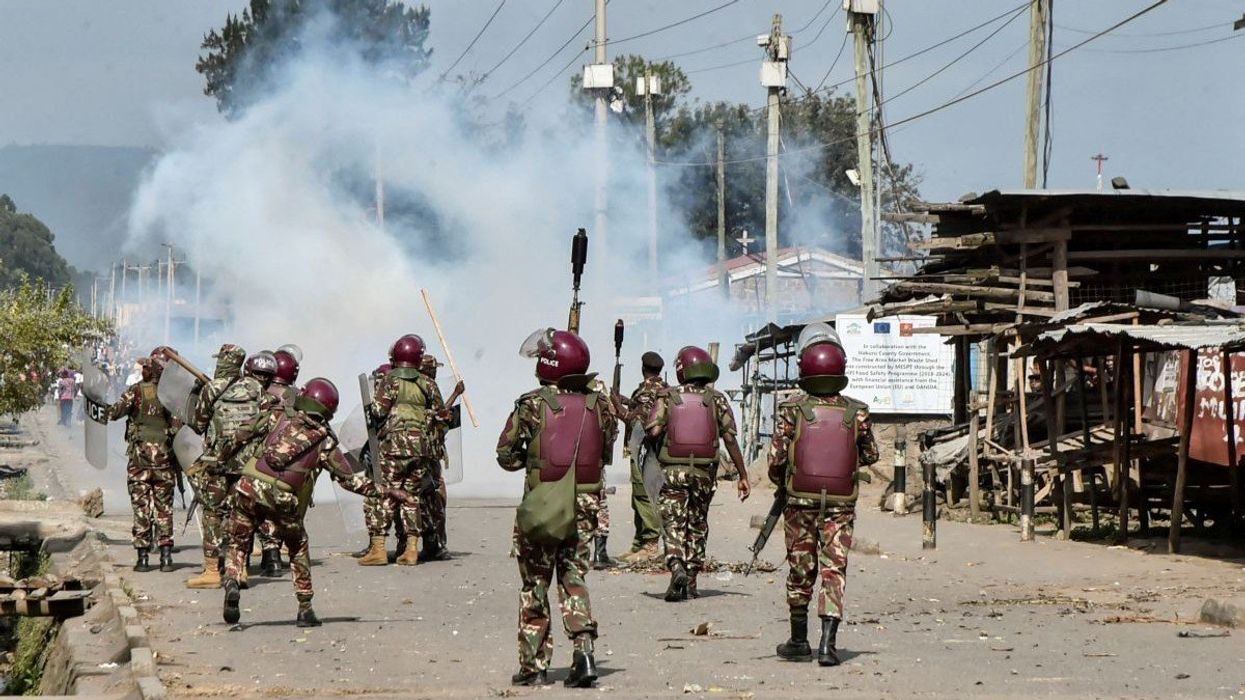 Riot police officers fire tear gas canisters to disperse demonstrators in the Rift Valley town of Nakuru, Kenya, on July 7, 2025.