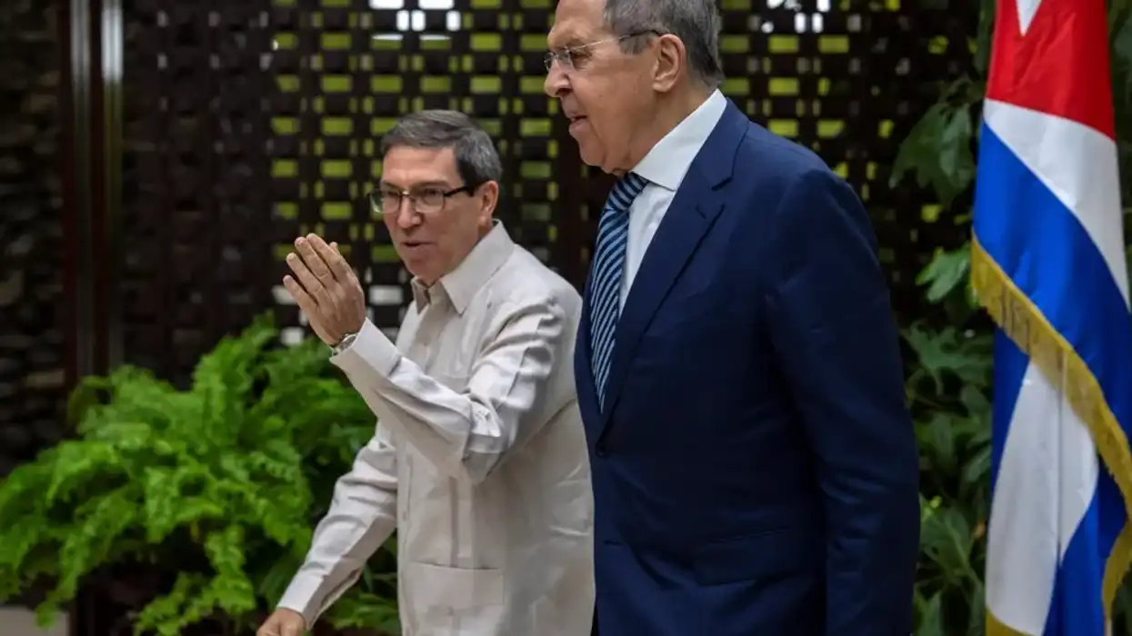 Russia's Foreign Minister Sergei Lavrov walks with Cuba's Foreign Minister Bruno Rodriguez during a meeting in Havana, Cuba, April 20, 2023