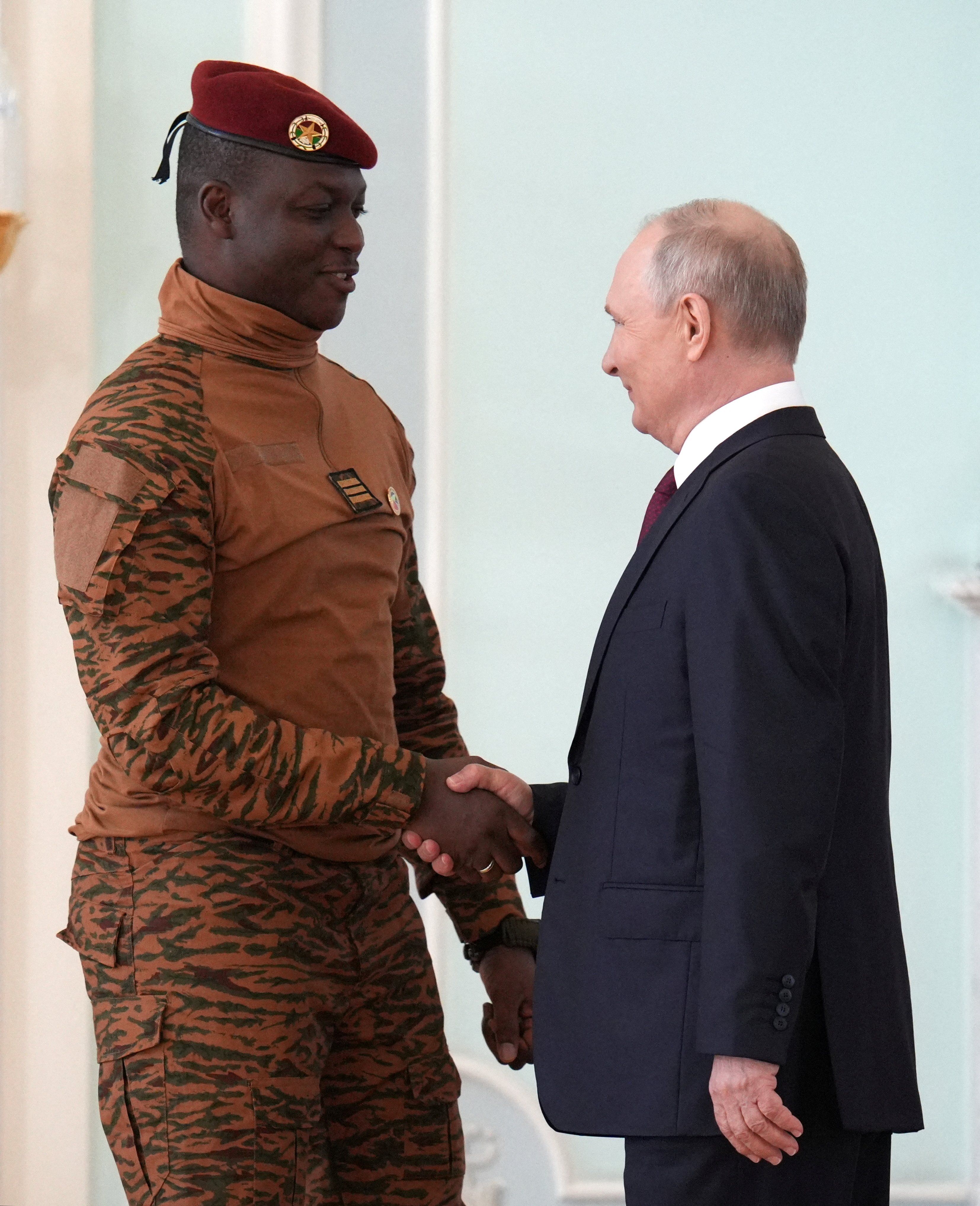 ​Russia's President Vladimir Putin shakes hands with Burkina Faso's interim President Ibrahim Traore at the Russia-Africa Summit in Russia in July.