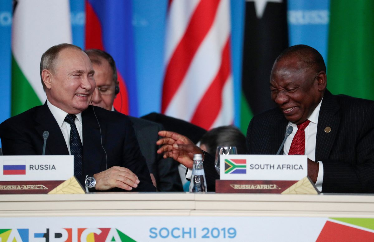 Russia's President Vladimir Putin smiles with South African President Cyril Ramaphosa in 2019