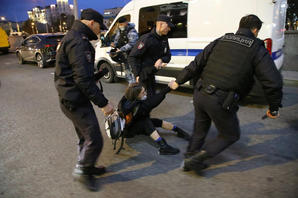 Russian police detain an anti-war protester in Moscow on September 21.