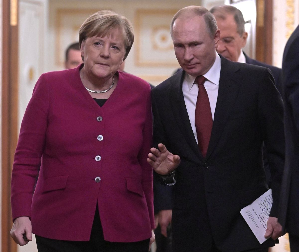 Russian President Vladimir Putin and German Chancellor Angela Merkel arrive for a joint news conference in Moscow