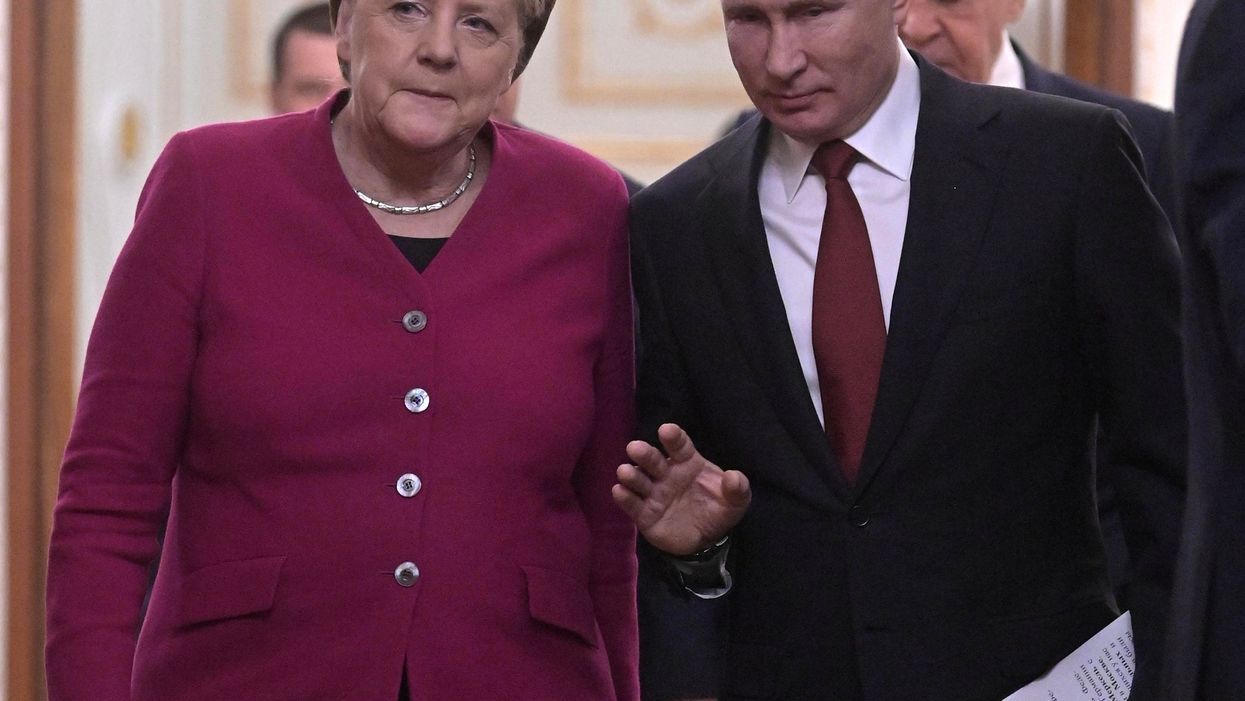 Russian President Vladimir Putin and German Chancellor Angela Merkel arrive for a joint news conference in Moscow