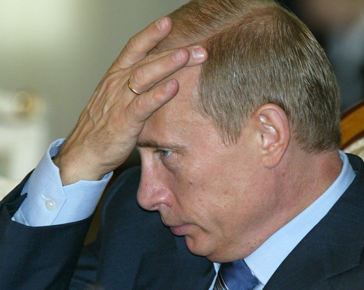 Russian President Vladimir Putin listens to a question at a press conference in the Kazakh capital of Astana, September 16, 2004.