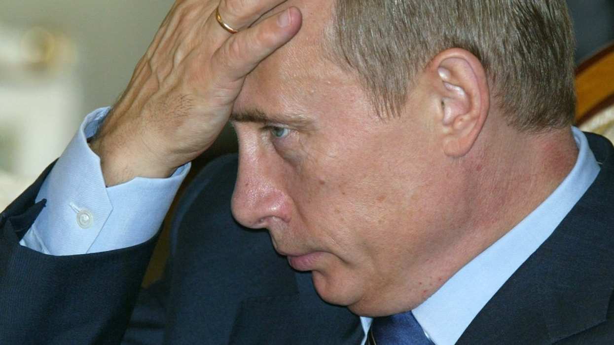 Russian President Vladimir Putin listens to a question at a press conference in the Kazakh capital of Astana, September 16, 2004.