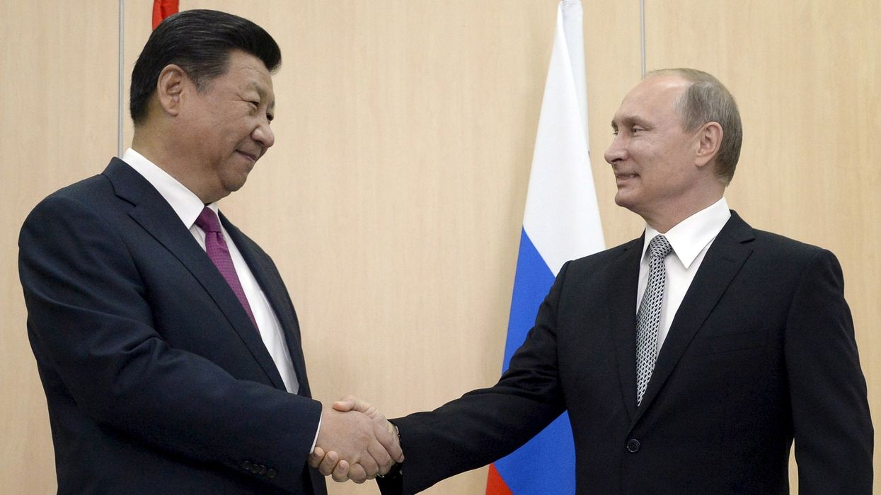 Russian President Vladimir Putin (R) shakes hands with Chinese President Xi Jinping during a meeting in Ufa, Russia, July 8, 2015. Vladimir Putin and Xi Jinping will attend the Shanghai Cooperation Organization (SCO) and the BRICS summits.