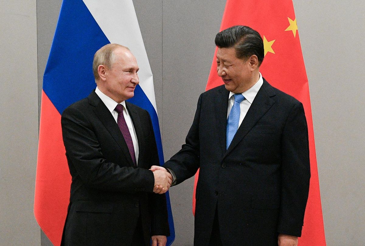Russian President Vladimir Putin shakes hands with Chinese President Xi Jinping, November 13, 2019. 