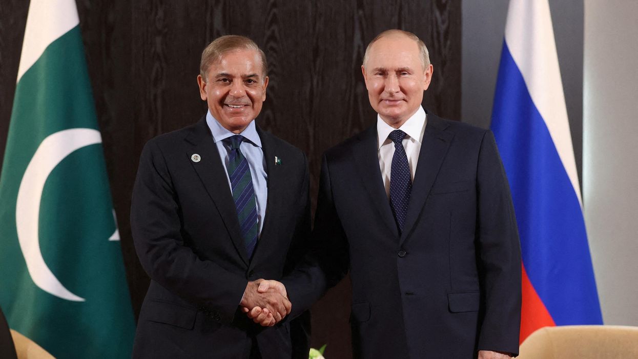Russian President Vladimir Putin shakes hands with Pakistani PM Shehbaz Sharif during a meeting on the sidelines of the Shanghai Cooperation Organization summit in Samarkand, Uzbekistan.