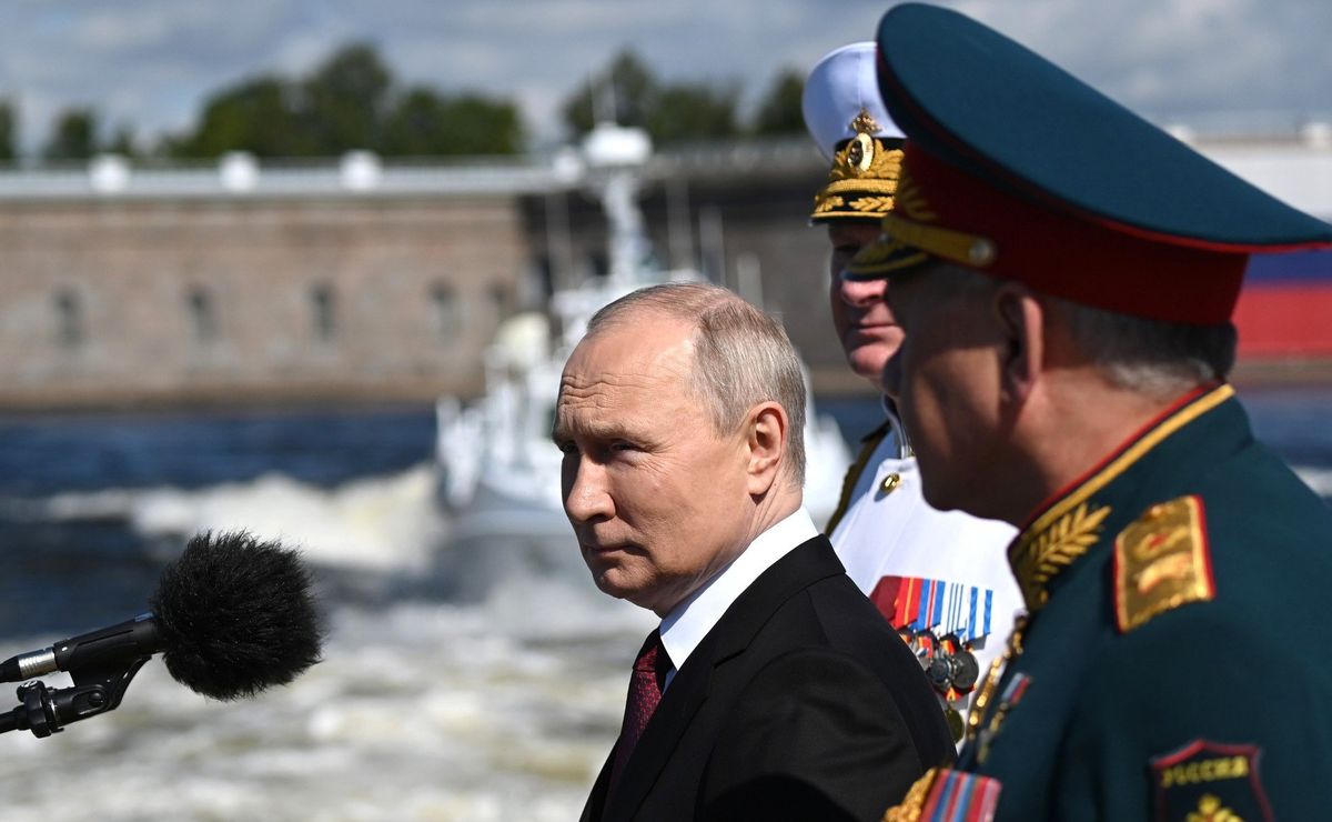 ​Russian President Vladimir Putin stands with Russian Defence Minister Sergei Shoigu during the Naval Parade marking Navy Day.
