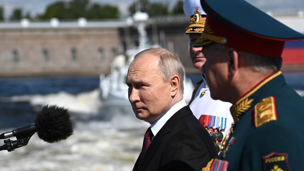 Russian President Vladimir Putin stands with Russian Defence Minister Sergei Shoigu during the Naval Parade marking Navy Day.