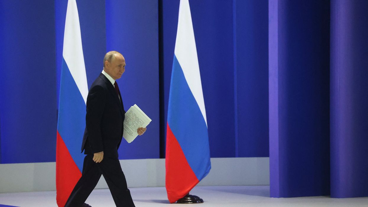 Russian President Vladimir Putin walks to deliver his annual address to the Federal Assembly in Moscow.
