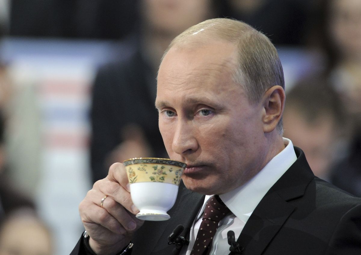 Russian Prime Minister Vladimir Putin drinks tea