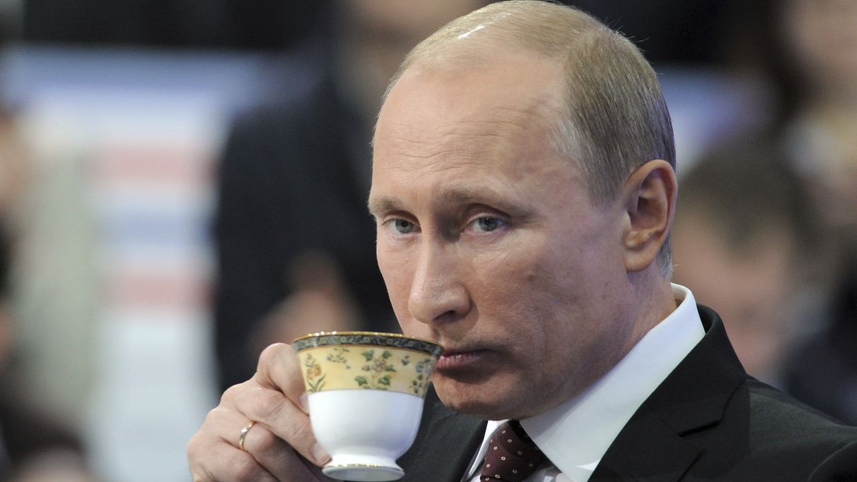 Russian Prime Minister Vladimir Putin drinks tea