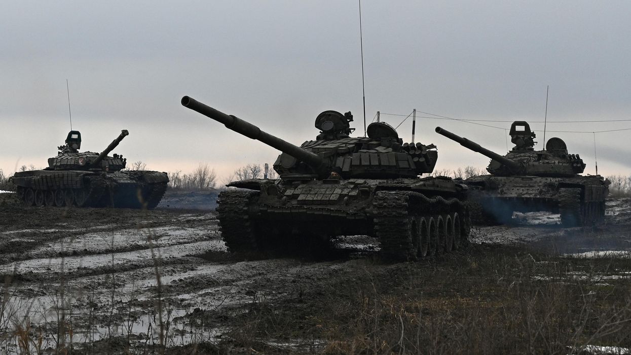 Russian service members drive tanks during drills held by the armed forces in the Rostov region, Russia.