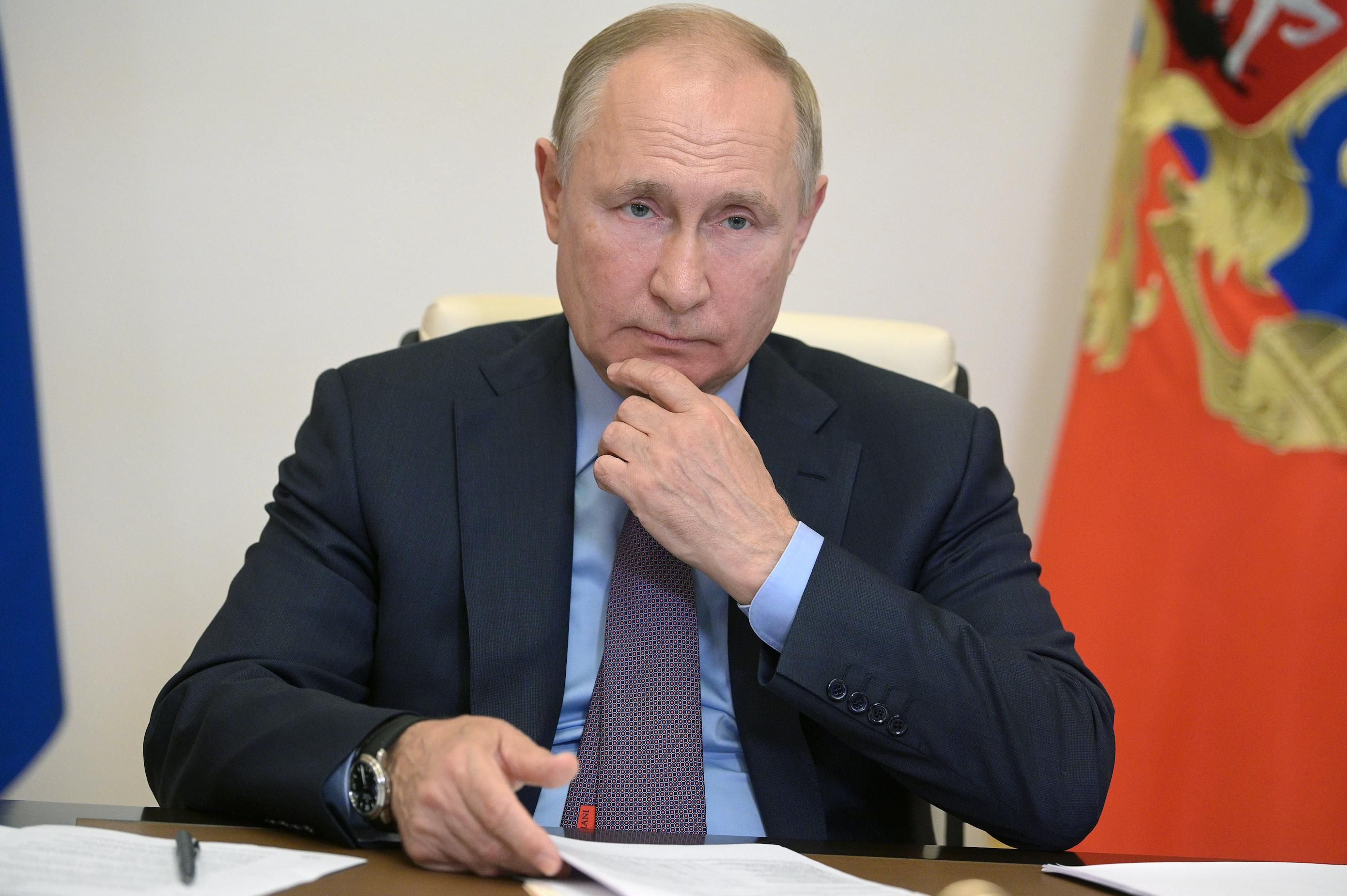 Russia’s President Vladimir Putin is seen in his office in the Novo-Ogaryovo residence during a videoconference meeting