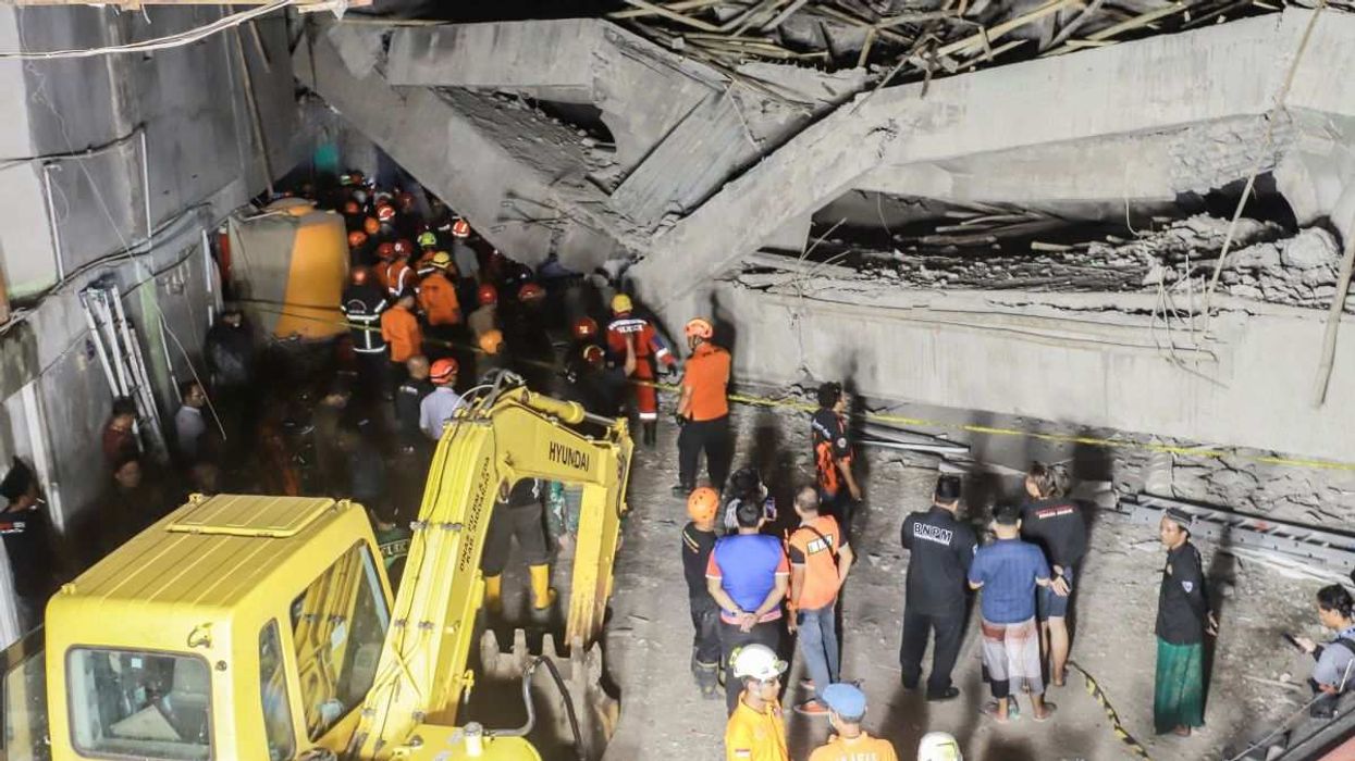 Search and rescue officers search for victims amidst the rubble of a collapsed school building in East Java, Indonesia, on September 29, 2025.