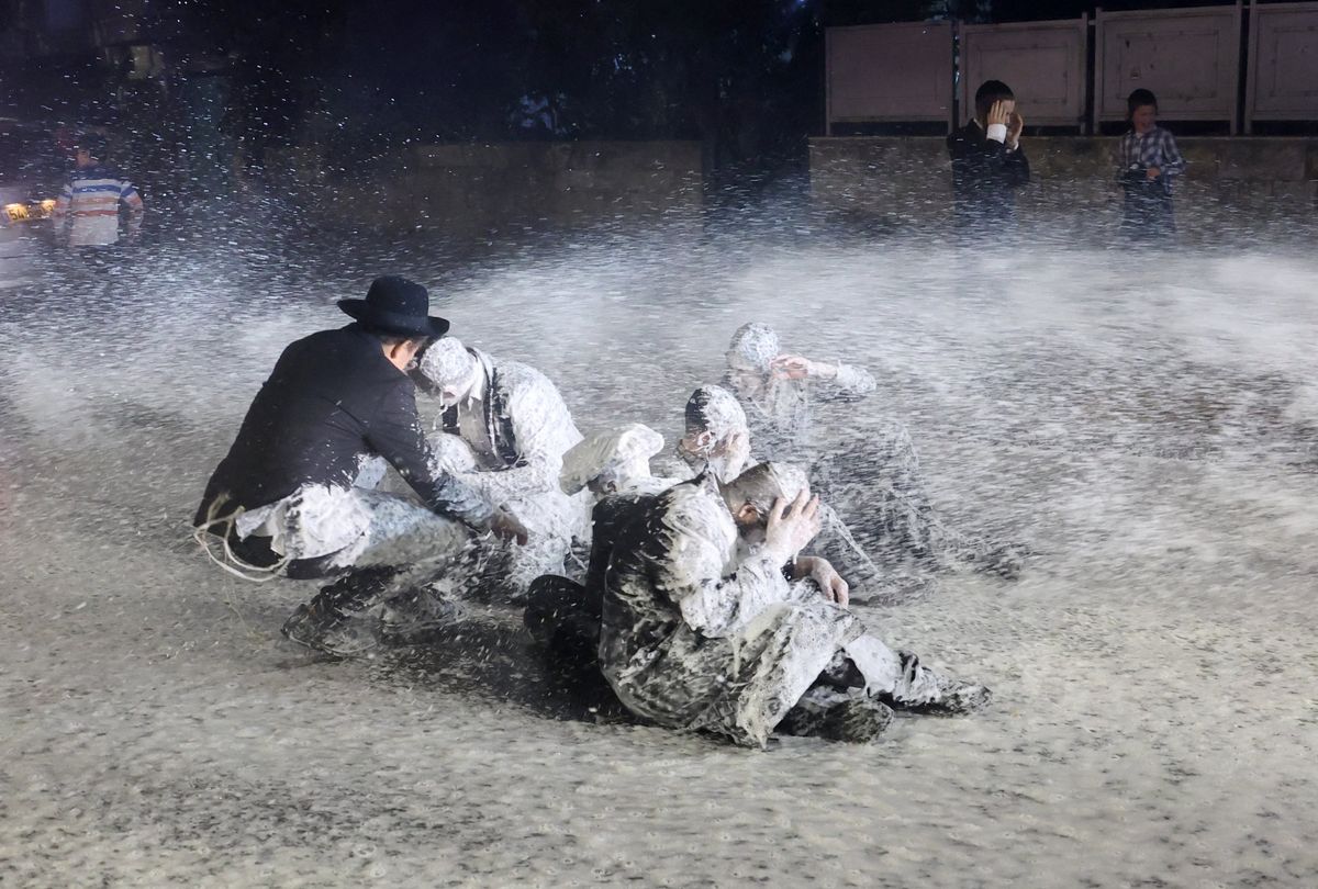 ​Security forces spray people as Ultra-Orthodox Jewish men protest an Israeli Supreme Court.