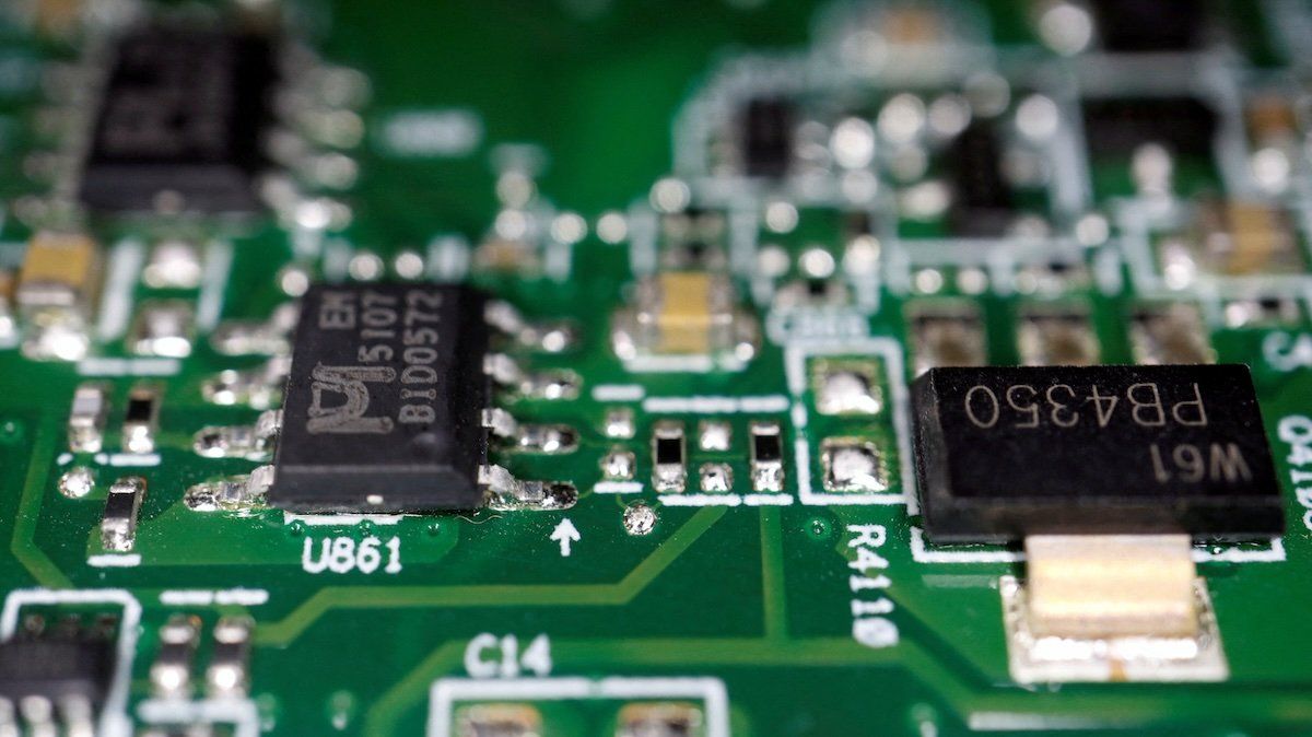Semiconductor chips are seen on a printed circuit board in this illustration picture taken February 17, 2023.