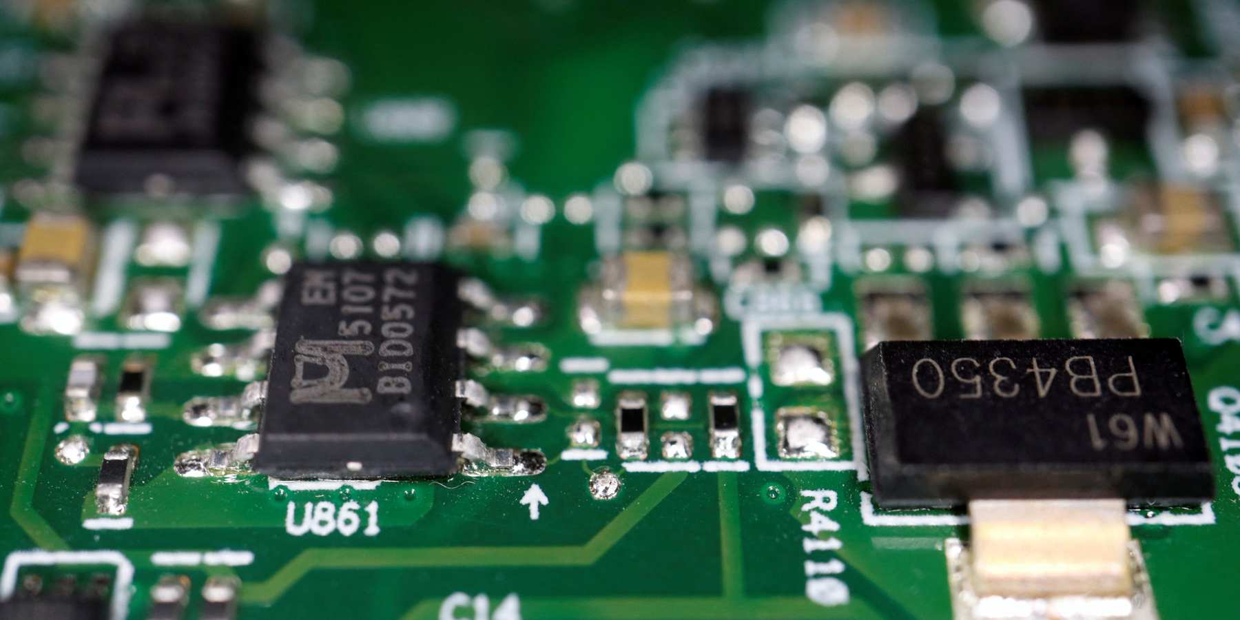 Semiconductor chips are seen on a printed circuit board in this picture.