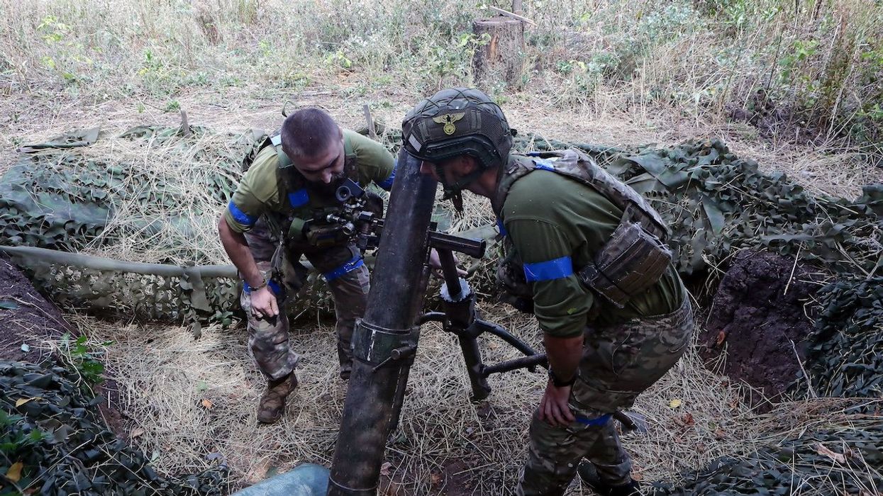 Servicemen of the 24th King Daniel of Galicia Separate Mechanized Brigade are firing a mortar at the positions of Russian troops near Chasiv Yar in Donetsk region, Ukraine, on August 14, 2024.