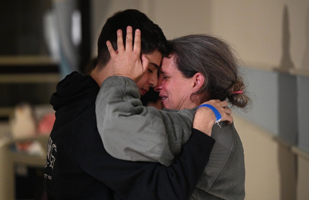 ​Sharon Hertzman hugs her son Omer at Sheba Medical Center after she was released by Hamas militants this weekend.