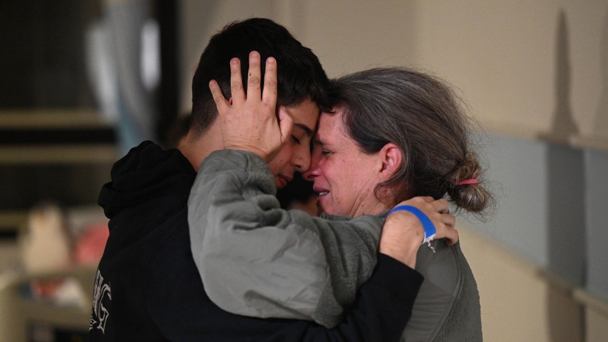 Sharon Hertzman hugs her son Omer at Sheba Medical Center after she was released by Hamas militants this weekend.